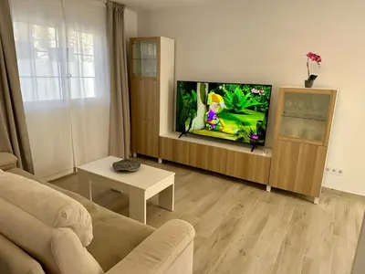 Una televisión o centro de entretenimiento en MODERN DUPLEX 50m FROM THE BEACH