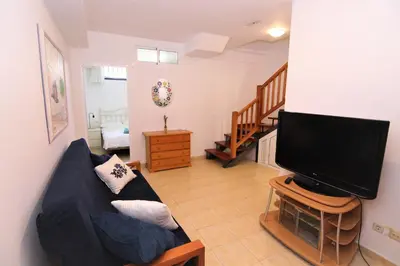 Una televisión o centro de entretenimiento en Bahia Meloneras 67 - 3 beds -