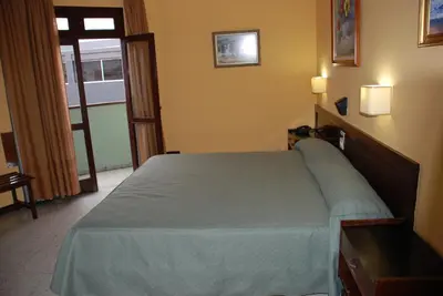 Cama o camas de una habitación en Hotel Olympia