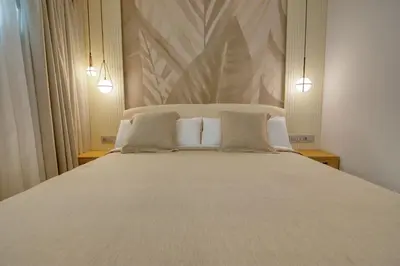 Cama o camas de una habitación en RELAXIA BEVERLY SUITES