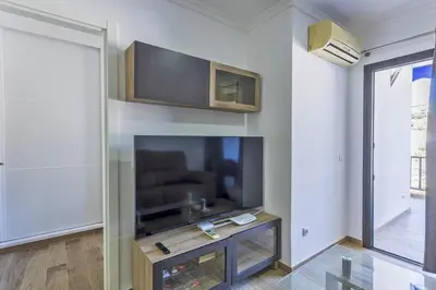 Una televisión o centro de entretenimiento en Atico Puerto Feliz 1 