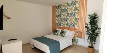 Cama o camas de una habitación en Bungalow Céntrico & Tranquilo