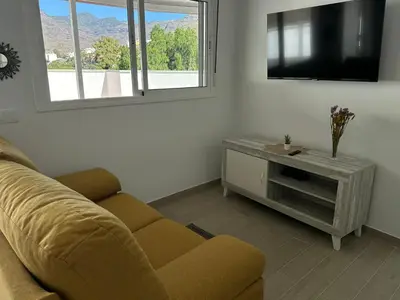 Una televisión o centro de entretenimiento en Apartamentos Casa Mime