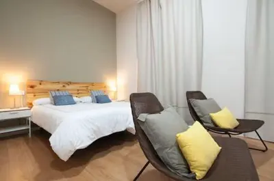 Cama o camas de una habitación en Triana 103 Rooms & Suites