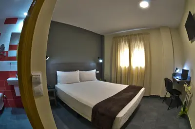 Cama o camas de una habitación en Hotel Puerto Canteras