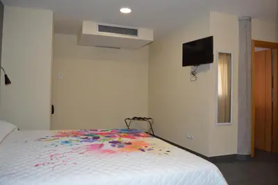 Cama o camas de una habitación en Hotel Puerto Canteras