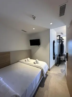 Cama o camas de una habitación en Oh SUITES Paseo de Las Canteras 58