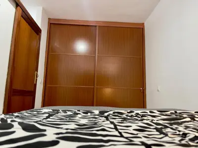Cama o camas de una habitación en FlatsBahiaArinaga En Playa de Arinaga con garaje
