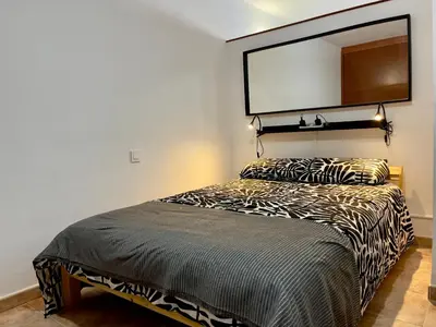Cama o camas de una habitación en FlatsBahiaArinaga En Playa de Arinaga con garaje