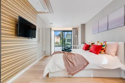 Cama o camas de una habitación en La Vega de Ciudad Jardín Suites
