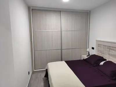 Cama o camas de una habitación en Piso cerca de la playa