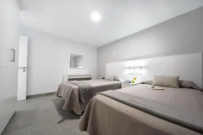 Cama o camas de una habitación en Apartamentos Los Papagayos
