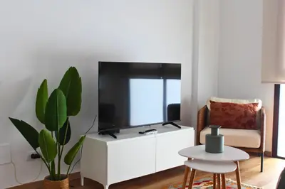 Una televisión o centro de entretenimiento en A los pies de Las Canteras - Atlantic Coral Bay