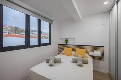 Cama o camas de una habitación en El Bunker Luxury Suite en Playa del Hombre con vista al mar