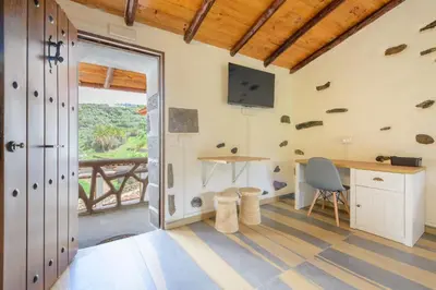 Una televisión o centro de entretenimiento en Quinta Entre Palmeras - Viviendas Vacacionales