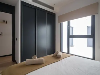 Cama o camas de una habitación en Apartamento Playa Las Canteras con gimnasio A2D