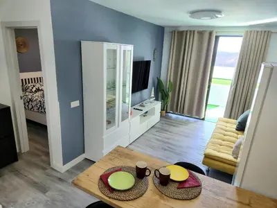 Una televisión o centro de entretenimiento en Suite Paradise Puerto Rico