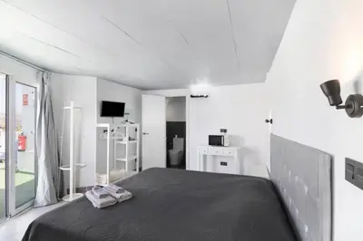 Una televisión o centro de entretenimiento en Suite con terraza y jacuzzi privada en Maspalomas