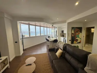 Zona de estar de Apartamento con vistas al mar piso 16 y a 5 min de la playa de Las Canteras CASA CARMELA