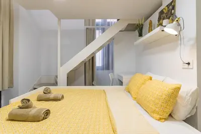 Cama o camas de una habitación en Beachside Groundfloor Apartment Las Canteras Shared Rooftop