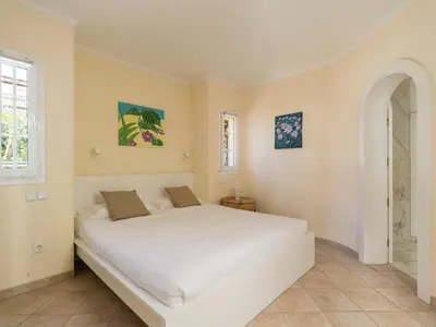 Cama o camas de una habitación en La Gloria Villas San Agustin