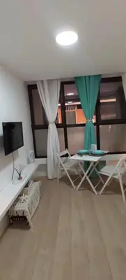 Una televisión o centro de entretenimiento en Right on the beach in Las Canteras - First line!