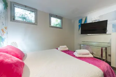 Cama o camas de una habitación en Suites Garden Loft Velázquez
