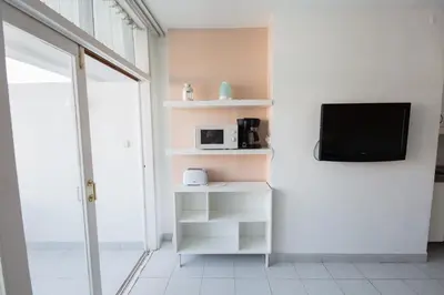 Una televisión o centro de entretenimiento en Apartamento Tobago