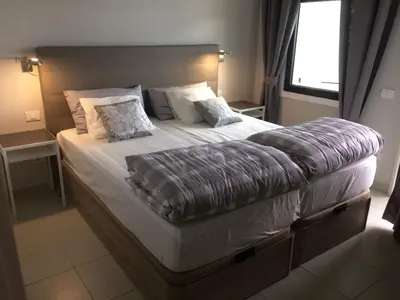 Cama o camas de una habitación en En plena playa de Las Canteras