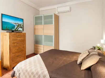 Cama o camas de una habitación en Beautiful Beach Apartment M&B IV by Las Canteras by VillaGranCanaria