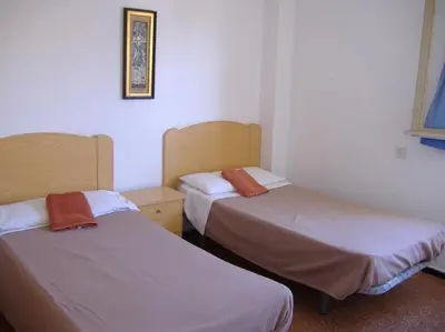 Cama o camas de una habitación en Hostal Casa de Huéspedes San Fernando - Adults Only