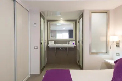 Cama o camas de una habitación en eó Corona Cedral
