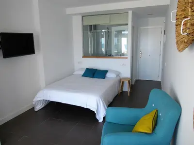 Cama o camas de una habitación en Vivelorural estudio Las Canteras vista mar- 307