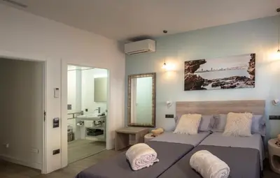 Cama o camas de una habitación en La Palmera Hotel Boutique