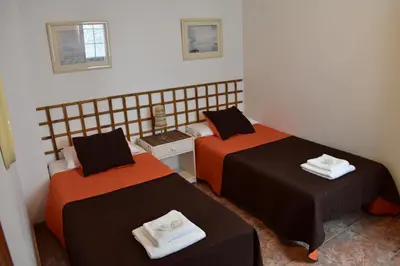 Cama o camas de una habitación en La Fonda Aeropuerto