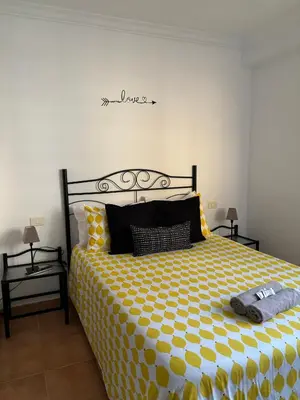 Cama o camas de una habitación en APARTAMENT SARDINA NEAR THE BEACH WITH POOL AND WIFI e