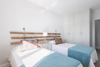 Cama o camas de una habitación en Living Las Canteras Homes - BRIGHT BEACHFRONT