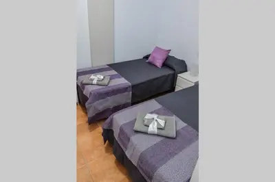 Cama o camas de una habitación en APARTAMENT SARDINA NEAR THE BEACH WITH POOL AND WIFI I