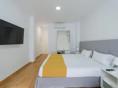 Cama o camas de una habitación en Ok Las Canteras Beach by CanariasGetaway