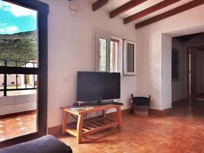 Una televisión o centro de entretenimiento en Casas Blancas - Suite 1