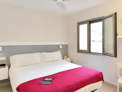 Cama o camas de una habitación en San Agustin Beach Apartments by VillaGranCanaria