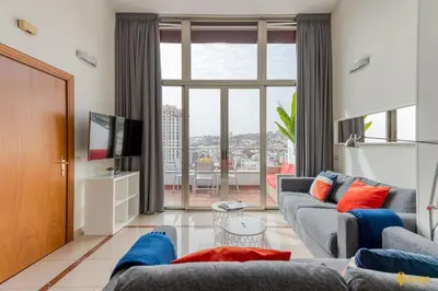 Una televisión o centro de entretenimiento en Living Las Canteras Homes - BEACHSIDE TERRACE BIKES