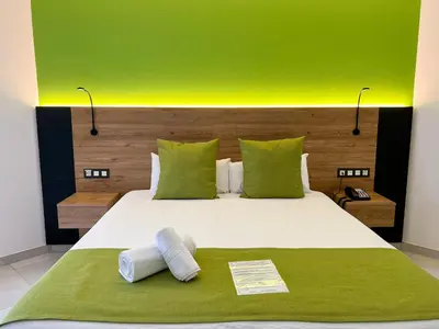 Cama o camas de una habitación en Hotel MG Poniente