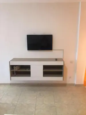 Una televisión o centro de entretenimiento en Apartamentos Teror - Gavias del Sol