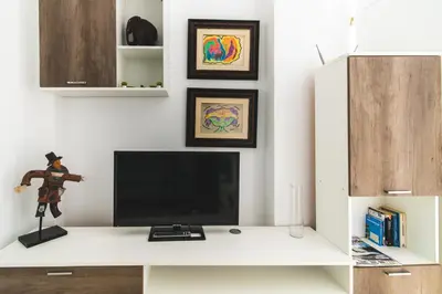 Una televisión o centro de entretenimiento en Home2Book Comfy Duplex La Isleta, BBQ & Wifi