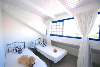 Cama o camas de una habitación en FABULOUS BUNGALOW , WIFI, SWIMMING POOL AND BEACH