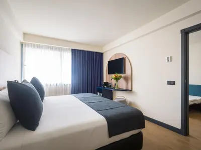 Cama o camas de una habitación en Sercotel Playa Canteras