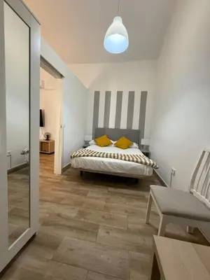 Cama o camas de una habitación en Casas La Aldea Suites Plaza