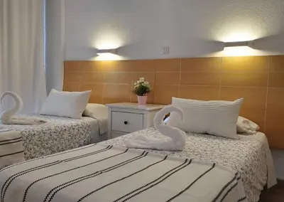 Cama o camas de una habitación en Las Camelias Apartments