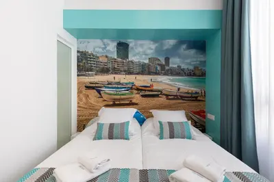 Cama o camas de una habitación en Petit Accommodation Las Canteras Deuxième